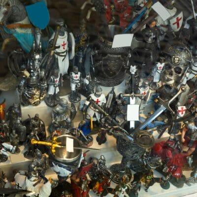 Multiple small action figures, like knights and horses, stuffed next to each other on a surface with multiple levels.