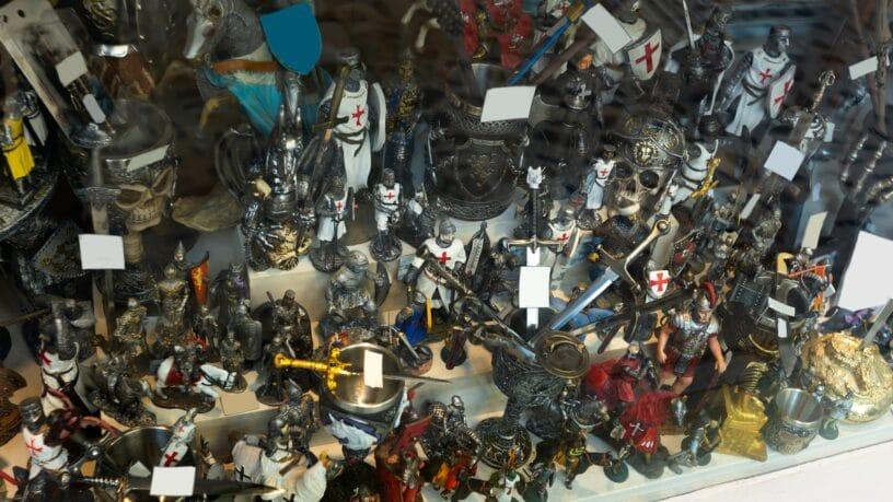 Multiple small action figures, like knights and horses, stuffed next to each other on a surface with multiple levels.