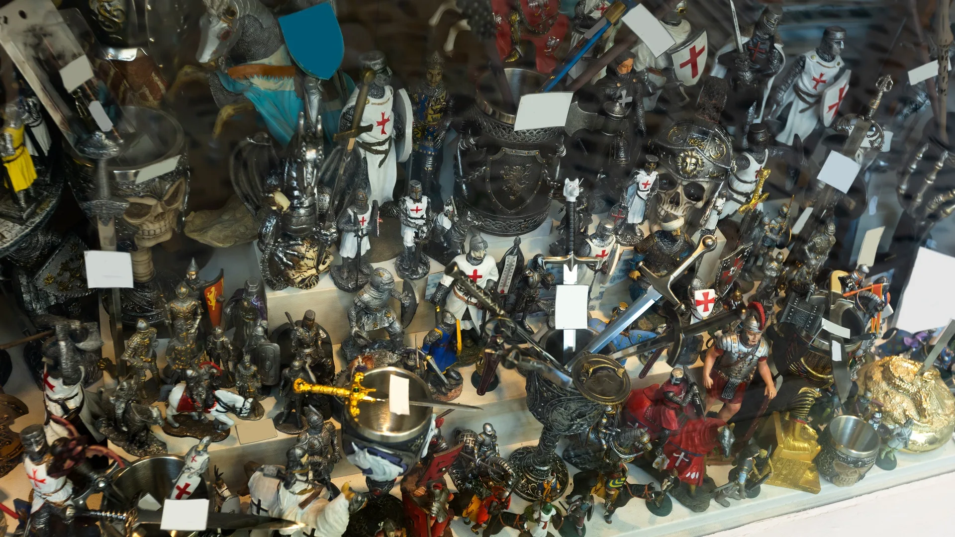 Multiple small action figures, like knights and horses, stuffed next to each other on a surface with multiple levels.